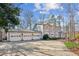 A three-car garage and brick paver driveway lead to a spacious house at 213 Pine Crest Dr, Cumming, GA 30040