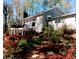 Ranch house with deck and lush landscaping in the backyard at 213 Pine Crest Dr, Cumming, GA 30040