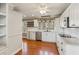 Bright kitchen features white cabinets, stainless steel appliances, and hardwood floors at 213 Pine Crest Dr, Cumming, GA 30040