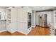 Stylish kitchen features white cabinets, stainless steel appliances, and hardwood floors at 213 Pine Crest Dr, Cumming, GA 30040