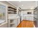 Modern kitchen with white cabinets, stainless steel appliances, and hardwood floors at 213 Pine Crest Dr, Cumming, GA 30040