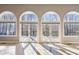Wall of windows and French doors in a sunlit living room at 213 Pine Crest Dr, Cumming, GA 30040
