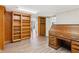 Home office with built-in shelving and rolltop desk at 213 Pine Crest Dr, Cumming, GA 30040
