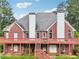 Brick house with large deck and stairs leading to backyard at 3071 N Tower Ne Way, Conyers, GA 30012