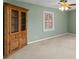 Bedroom with green walls, neutral carpet, and a wooden hutch cabinet at 3521 Southern Bay Ct, Snellville, GA 30039