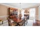 Formal dining room features a chandelier, china cabinet, and large wood table with seating at 3521 Southern Bay Ct, Snellville, GA 30039