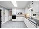 Well-lit kitchen featuring white cabinets, stainless steel appliances, and granite countertops at 3521 Southern Bay Ct, Snellville, GA 30039