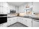 Well-lit kitchen features white cabinets, granite countertops, and stainless steel appliances at 3521 Southern Bay Ct, Snellville, GA 30039