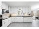 Bright kitchen features white cabinets, granite countertops, and stainless steel appliances at 3521 Southern Bay Ct, Snellville, GA 30039