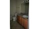 Bathroom with tile flooring, wood cabinets, and a granite countertop at 11329 Michelle Way, Hampton, GA 30228