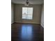 This bedroom is equipped with a ceiling fan, hardwood floors, and a large window at 11329 Michelle Way, Hampton, GA 30228