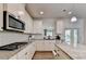 Well-equipped kitchen with granite countertops, gas cooktop, and white shaker cabinets at 1816 Hamilton Lake Pkwy, Buford, GA 30519