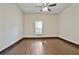 Bright, spacious bedroom featuring wood-look tile flooring and a ceiling fan at 141 Rivertown Rd, Fairburn, GA 30213