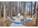 Relaxing backyard with a hammock, seating by the firepit, and a shed in the woods at 305 Thorntree Ln, Canton, GA 30115