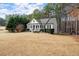 Lovely exterior of home with black shutters, covered entryway, and large front lawn at 305 Thorntree Ln, Canton, GA 30115