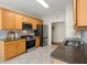 Kitchen with stainless steel appliances, wooden cabinets, and granite countertops at 305 Thorntree Ln, Canton, GA 30115