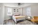 Spacious bedroom with queen bed, hardwood floors, and window coverings at 300 Peachtree Ne St # 3B, Atlanta, GA 30308