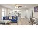Living room with blue sofa, kitchen and breakfast bar, hardwood floors at 300 Peachtree Ne St # 3B, Atlanta, GA 30308
