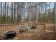 Deck with firepit overlooking a wooded backyard at 7037 Shangrila Trl, Riverdale, GA 30296