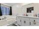 Bathroom with a soaking tub and updated vanity at 7037 Shangrila Trl, Riverdale, GA 30296