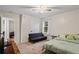 Spacious bedroom with a large bed, couch, and access to another room at 7037 Shangrila Trl, Riverdale, GA 30296