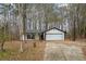 Ranch home with attached garage, nestled in a wooded lot at 7037 Shangrila Trl, Riverdale, GA 30296