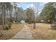 House with driveway, surrounded by wooded area at 7037 Shangrila Trl, Riverdale, GA 30296