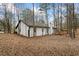 Back of house with deck and wooded area at 7037 Shangrila Trl, Riverdale, GA 30296