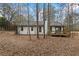 Back of house with deck and wooded area at 7037 Shangrila Trl, Riverdale, GA 30296