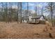 Back of house with deck and wooded area at 7037 Shangrila Trl, Riverdale, GA 30296