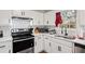 Updated kitchen with stainless steel appliances and white cabinets at 7037 Shangrila Trl, Riverdale, GA 30296