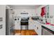 Modern kitchen featuring white cabinets, quartz countertops and stainless steel appliances at 7037 Shangrila Trl, Riverdale, GA 30296