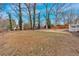 Expansive backyard featuring a trampoline and mature trees at 1119 Oakdale Se Dr, Smyrna, GA 30080