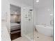 Bright bathroom with modern soaking tub, shower with glass doors, and a view to the bedroom at 1119 Oakdale Se Dr, Smyrna, GA 30080