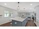 Bright kitchen features a large island, pendant lighting, and modern white cabinets at 1119 Oakdale Se Dr, Smyrna, GA 30080