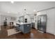 Modern kitchen with a blue island, stainless steel appliances, and an open layout connected to the dining area at 1119 Oakdale Se Dr, Smyrna, GA 30080