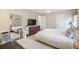 Bright, neutral main bedroom featuring a white-patterned comforter and a dark wood dresser with flat screen tv at 1119 Oakdale Se Dr, Smyrna, GA 30080