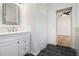 Clean bathroom with a white vanity and dark tile floors at 2676 Old Toney Rd, Ellenwood, GA 30294