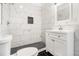 Modern bathroom with white marble tile and a white vanity at 2676 Old Toney Rd, Ellenwood, GA 30294