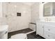 Modern bathroom with a white vanity, marble shower, and dark tile floors at 2676 Old Toney Rd, Ellenwood, GA 30294