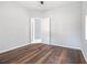 Bright bedroom with wood-look floors and an open door to another room at 2676 Old Toney Rd, Ellenwood, GA 30294