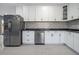 Modern kitchen with white shaker cabinets and dark countertops at 2676 Old Toney Rd, Ellenwood, GA 30294