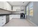 Modern kitchen with white cabinets, and stainless steel appliances at 2676 Old Toney Rd, Ellenwood, GA 30294