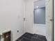 Laundry room with access to another room and dark tile floor at 2676 Old Toney Rd, Ellenwood, GA 30294