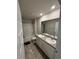 Clean bathroom featuring a shower-tub combo, dual sink vanity, and vinyl flooring at 3306 Loblolly Pine Way, Decatur, GA 30034