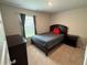 Comfortable bedroom with a bed, end table, and natural light from the window at 3306 Loblolly Pine Way, Decatur, GA 30034