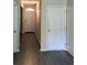 Hallway with neutral walls and wood look flooring leading to front door at 3306 Loblolly Pine Way, Decatur, GA 30034