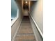 Neutral carpeted stairway with neutral walls and white handrail at 3306 Loblolly Pine Way, Decatur, GA 30034