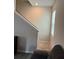 Carpeted stairs with white rail and gray walls featuring a window at 3306 Loblolly Pine Way, Decatur, GA 30034