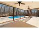 Covered back patio with ceiling fans and views of backyard pool and landscaping at 5073 Kingsbridge Pass, Powder Springs, GA 30127